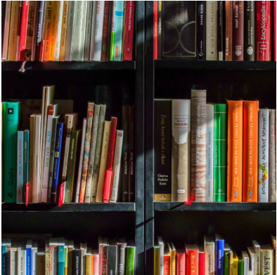 Six shelves filled with books of different sizes and colors.